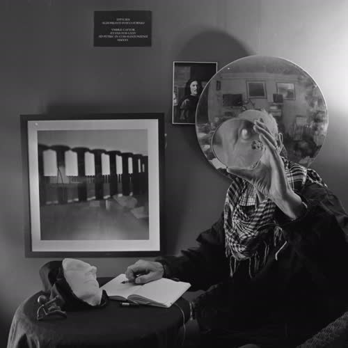 <body>
 <p>
  This series,<i> Self-portrait, after Poussin</i> explores how we see ourselves over time. The plaster mask is a self-portrait made years ago: it represents the past self, fixed and unchanging. The round glass lens stands for photography and the present moment, always shifting with light. The mirror shows that identity is never just individual but always in relation to others.
 </p>
 <p>
In the 1649 painting, Poussin included statuary and a ring referencing Stoic philosophy. Stoicism taught that life is shaped by time, change, and the need to accept what is beyond our control. Poussin used these icons to show himself not only as an artist, but also as someone seeking wisdom in a changing world.
 </p>
 <p>
In today’s age, these ideas still feel relevant. The plaster mask recalls memory and permanence, but the lens and mirror suggest the constant flux of the present and our ties to others. Like the Stoics, the project reflects on how we live with change and find steadiness in self-understanding. Philosopher Paul Ricoeur’s writings on identity deepen this reflection: we are at once the same person over time and always becoming someone new.
 </p>
</body>
 Images Copyright Aldobranti® ©2008-'2025. All rights reserved.